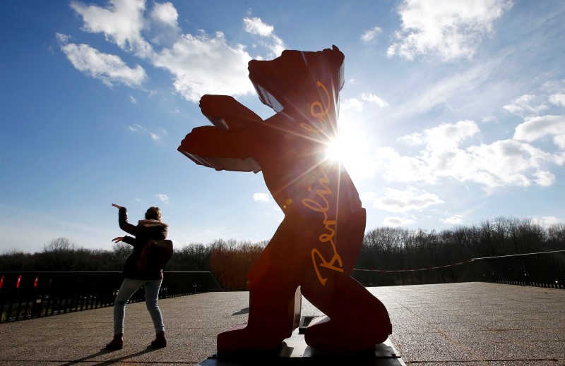 A woman stands beside the logo for the upcoming 66th Berlinale International Film Festival in Berlin, Germany, February 10, 2016. u00e2u20acu201d Reuters pic