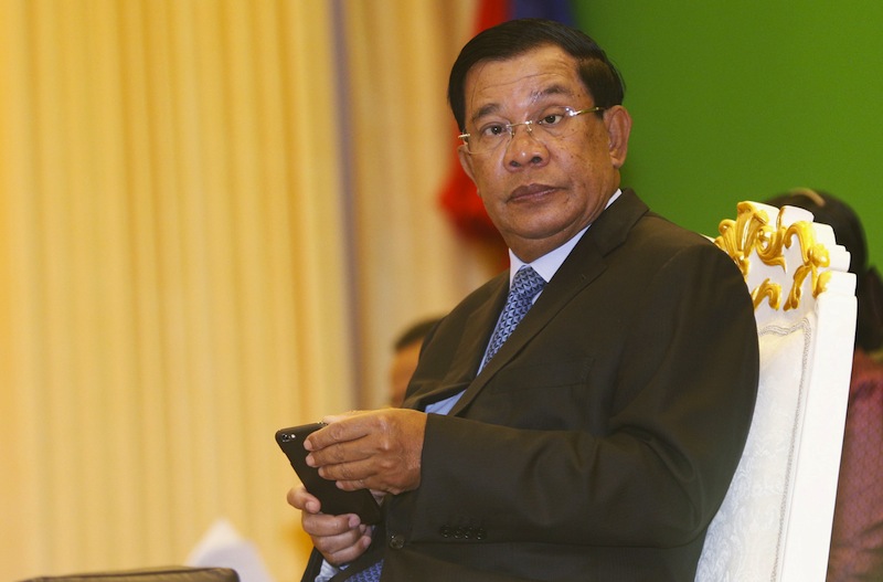 Cambodia's Prime Minister Hun Sen looks up from his smartphone at a ceremony in Phnom Penh February 25, 2016. u00e2u20acu201d Reuters pic
