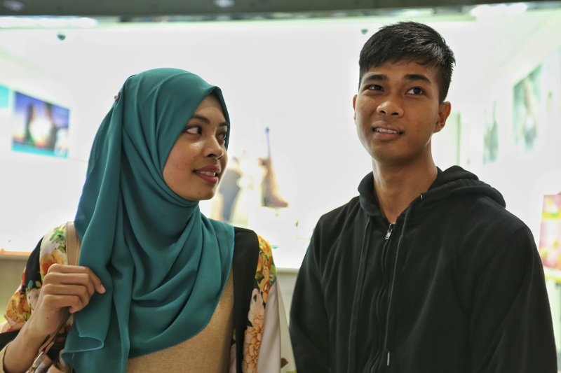 Customer service officer Ain Suhaimi, (left) feels that it is ‘un-Islamic’ to go to a restaurant that does not have the halal certification. — Picture by Saw Siow Feng