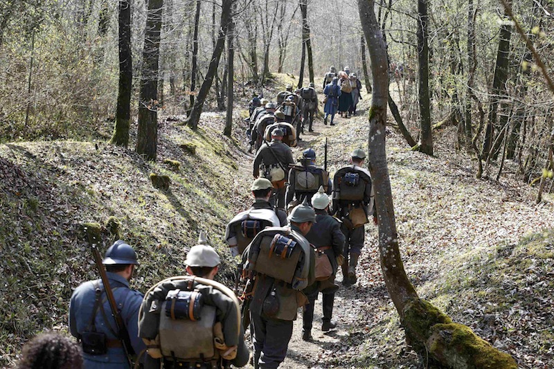 French (in blue) and German members of World War One historical associations march in a trench near the bunker of Bezonvaux in the national forest of Verdun, France, in this picture taken on March 29, 2014. u00e2u20acu201d Reuters pic