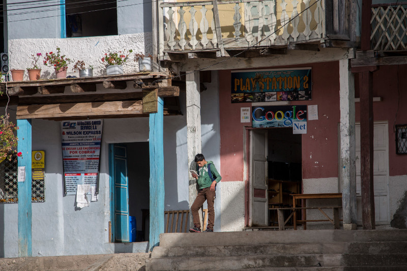 A man reads along the edge of the square in Quingeo, Ecuador.