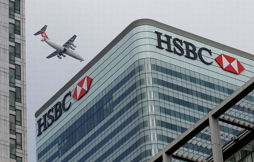 A Swiss International aircraft flies past the HSBC headquarters building in the Canary Wharf financial district in east London February 15, 2015. u00e2u20acu201d Reuters pic 