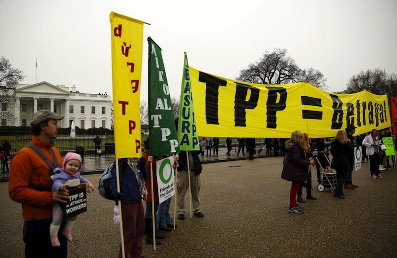Chris Zang (left) and his seven-month old daughter Ruby, join opponents of the Trans Pacific Partnership trade agreement protest outside of the White House in Washington February 3, 2016. u00e2u20acu201d Reuters pic