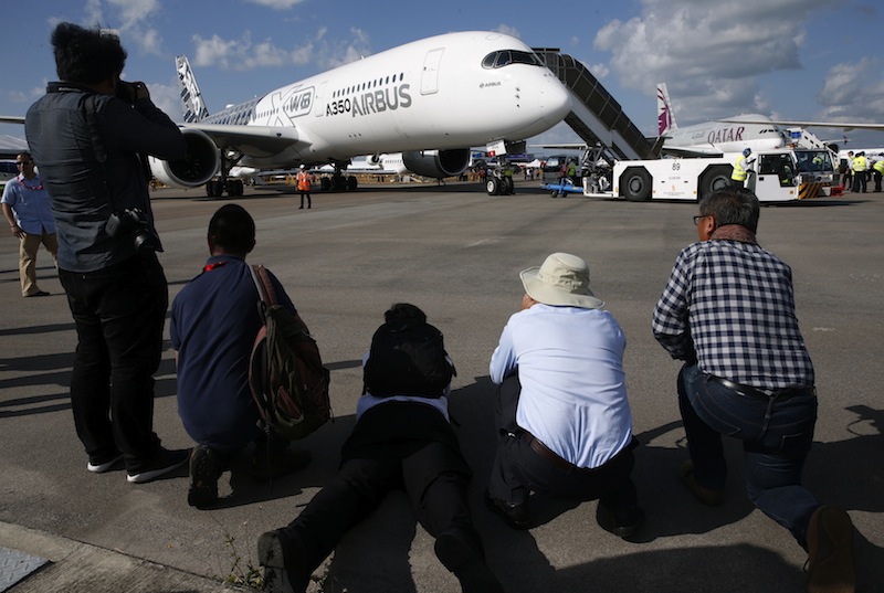 Aviation enthusiasts crowd around to take photos of an Airbus A350 XWB on display during the opening day of the Singapore Airshow at Changi Exhibition Centre February 16, 2016. u00e2u20acu201d Reuters pic
