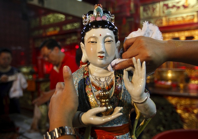 A volunteer cleans a statue ahead of the Lunar New Year celebrations at Vihara Dharma Bhakti Temple in Jakarta, Indonesia, February 3, 2016. u00e2u20acu201d Reuters pic