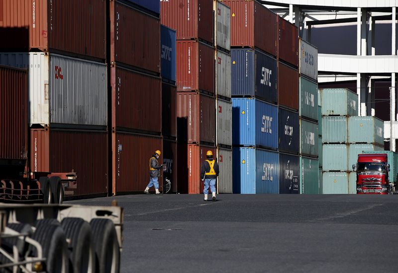 Workers walk in a container area at a port in Tokyo, January 25, 2016. Japan's exports fell the most in more than three years in December from a year earlier. u00e2u20acu201d Reuters pic