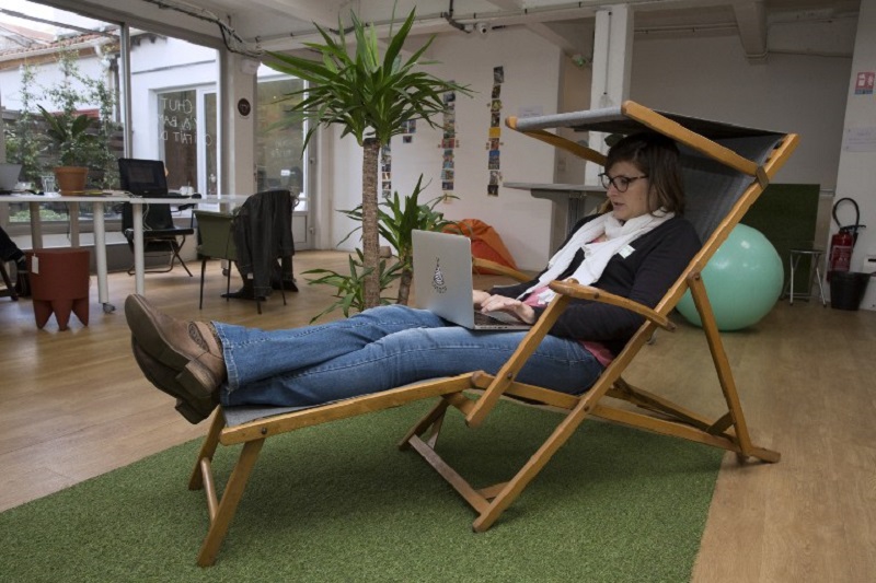 A woman sits in a deckchair as she works on a laptop at the u00e2u20acu02dcCasacou00e2u20acu2122 co-working space in Malakoff in this September 23, 2015 file picture. u00e2u20acu201d AFP pic