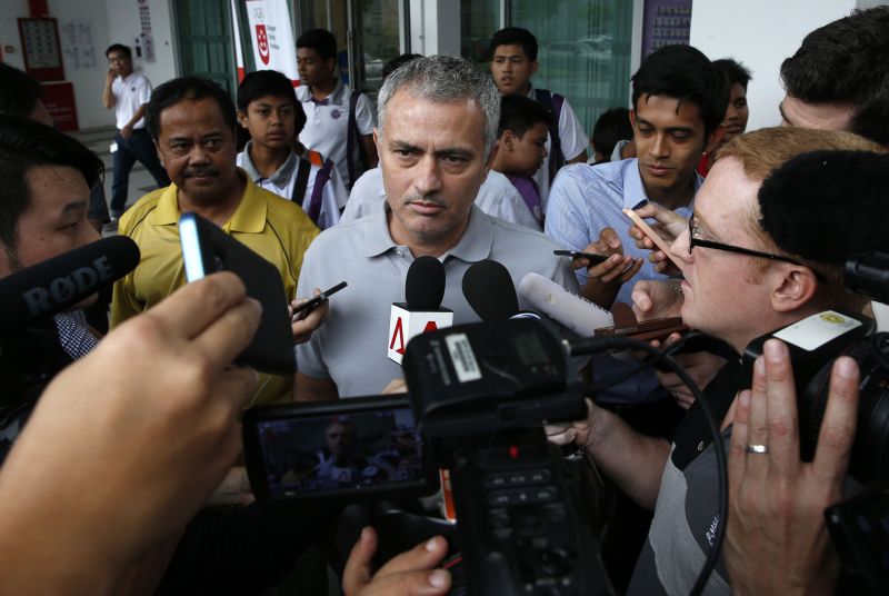 Former Chelsea manager Jose Mourinho (C) speaks to the media after a visit to NorthLight School in Singapore February 24, 2016. REUTERS/Edgar Su