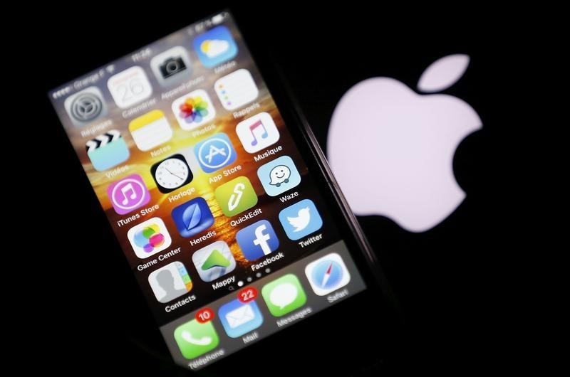 An Apple iPhone is pictured next to the logo of Apple in Bordeaux, southwestern France, February 26, 2016. u00e2u20acu201d Reuters pic