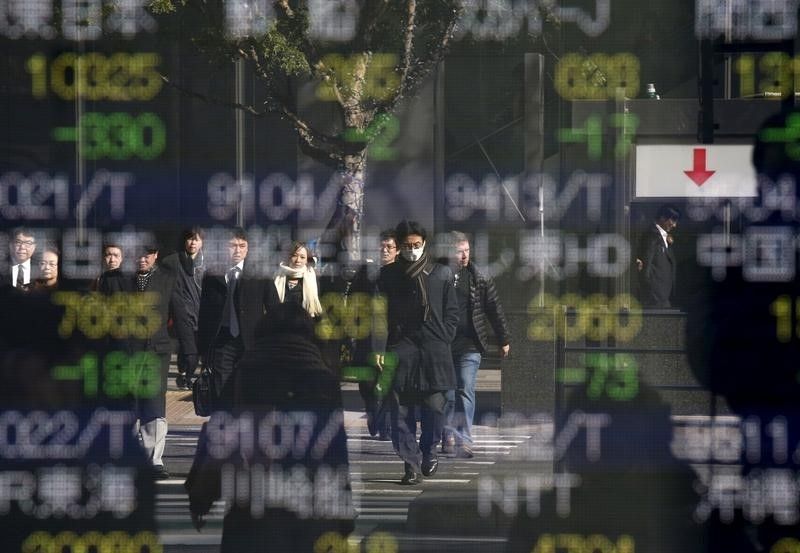 People are reflected in a stock quotation board outside a brokerage in Tokyo, January 14, 2016. u00e2u20acu201d Reuters pic
