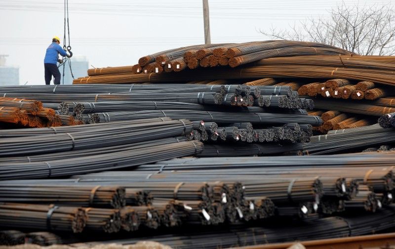 A labourer works at a steel market in Shanghai January 9, 2013. REUTERS/Aly Song