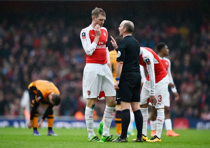 Arsenal's Per Mertesacker is spoken to by referee Mike Dean in the FA Cup fifth round at the Emirates Stadium, February 20, 2016. u00e2u20acu201d Reuters pic
