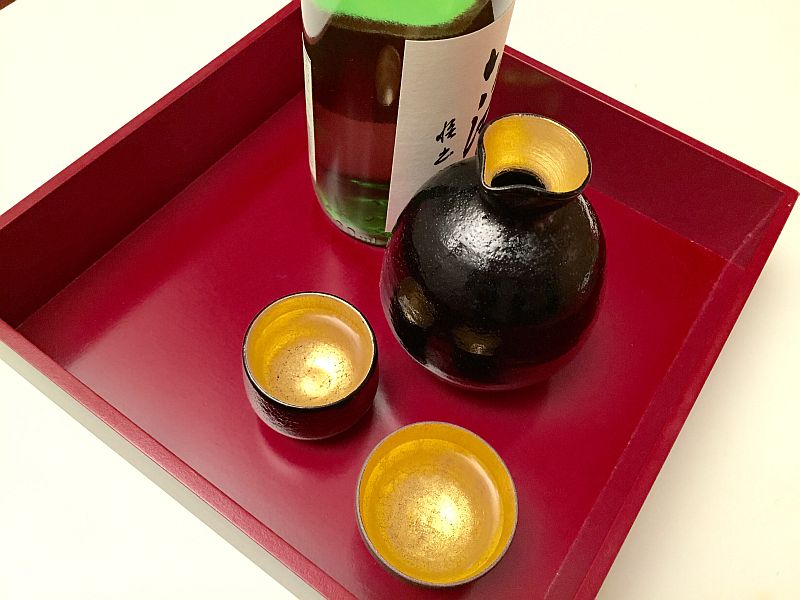 A bottle of sake with a traditional ceramic carafe and small cups known as o-choko. u00e2u20acu201d Picture courtesy of Hiroko Shimbo