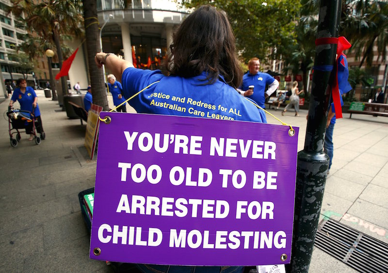 nVictims and relatives of children who claim they were sexually abused by the Catholic Church hold placards as they stand outside the venue for Australia's Royal Commission into Institutional Response to Child Sexual Abuse in Sydney, Australia, February 2