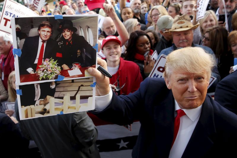 US Republican presidential candidate Donald Trump holds up a photo of himself and the late Michael Jackson that a memorabilia collector asked him to sign as he greets supporters after in Walterboro, South Carolina February 18, 2016. u00e2u20acu2022 Reuters pic