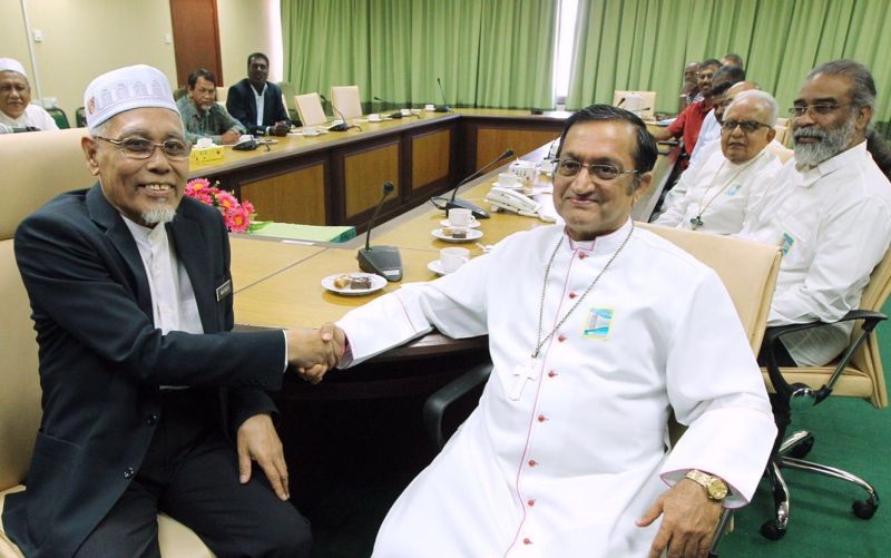 Penang Mufti Datuk Dr Wan Salim Wan Mohd Noor (left) shaking hands with Bishop Francis at the first interfaith meeting at the former's office in Komtar today. u00e2u20acu2022 Courtesy pic