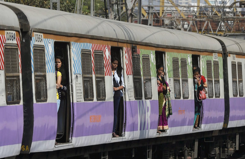 Commuters stand on the doors of a suburban train as it approaches the Churchgate railway station in Mumbai February 25, 2016. u00e2u20acu201d Reuters pic