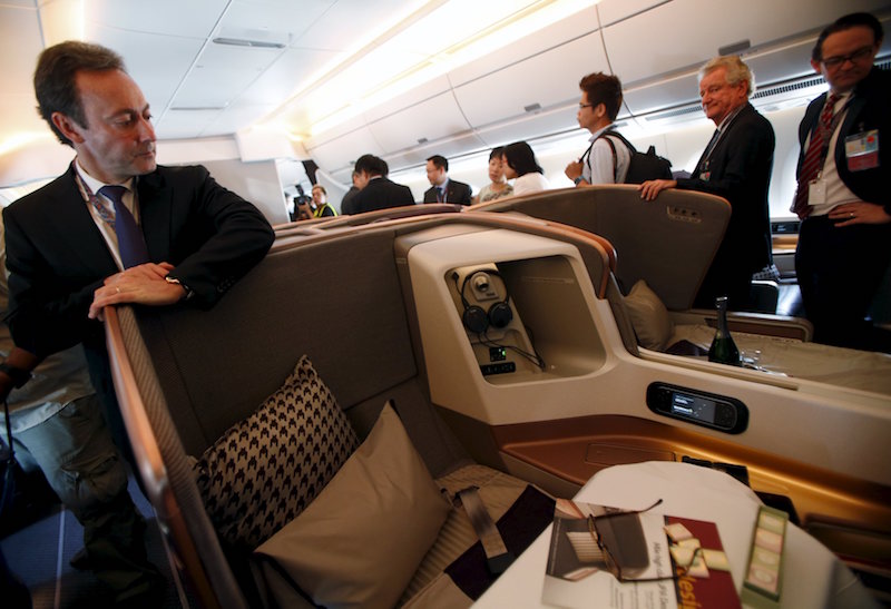 Fabrice Bregier, President and CEO of Airbus, looks at a business class seat during a tour of the first of 67 new Airbus A350-900 planes delivered to Singapore Airlines at Singapore’s Changi Airport March 3, 2016. — Reuters pic