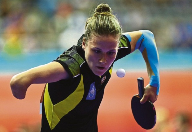 Partyka uses the crook of her right elbow to serve. u00e2u20acu201d Picture by Azneal Ishak