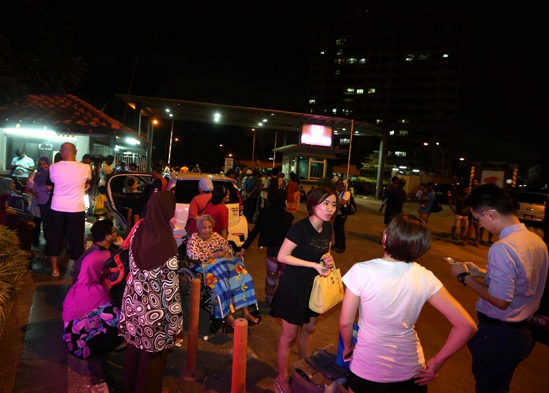 People gather below their apartment after experiencing tremors last night, in Johor Baru. Picture released on March 3, 2016. u00e2u20acu201d Bernama pic