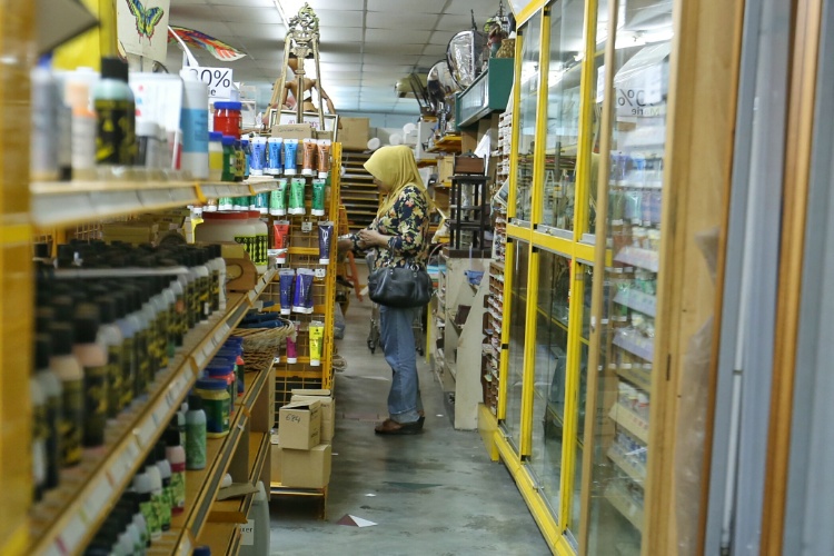 A customer browsing at the well-stocked and well-organised Venus Art, which some customers claim continues to afford cheaper prices compared to other outlets.