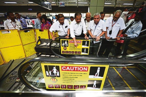 (From left) MRCB executive vice-president Datuk Ishak Mohamed, Aziz, Dell and MRCB general manager of security and safety Datuk A. Paramasivam checks on the progress of repairs to an escalator in KL Sentral during his walkabout recently. u00e2u20acu201d Picture by Ah