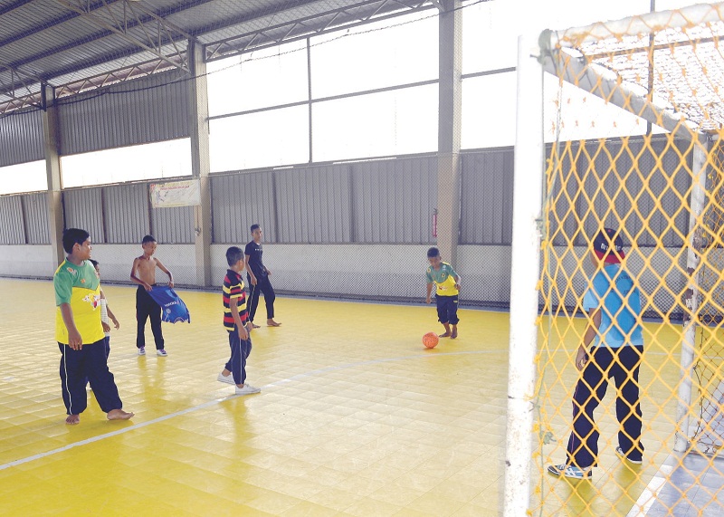 A group of boys enjoy the day off school with a game of futsal.u00e2u20acu201d Picture by R. Mahgeshan