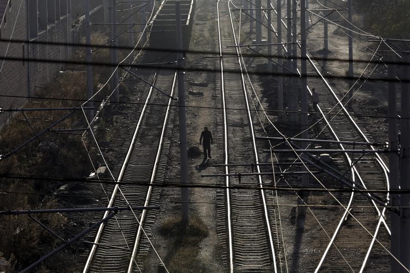 Local villagers walk along railways, which are used to transfer coal, at Zhengyang coal mine from the state-owned Longmay Group on the outskirts of Jixi, China, October 22, 2015. u00e2u20acu201d Reuters pic