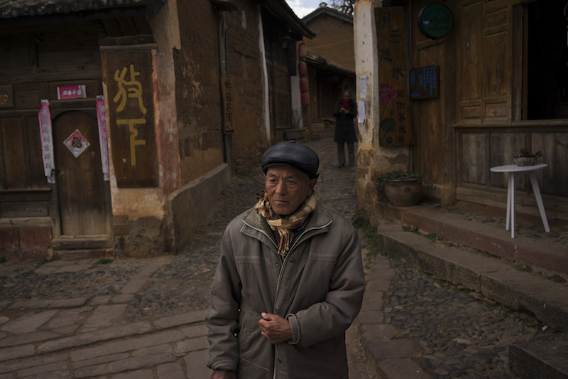 A man walks through the square of Sideng Village in the old town centre of Shaxi, China, January 28, 2016. — Picture by Adam Dean/The New York Times