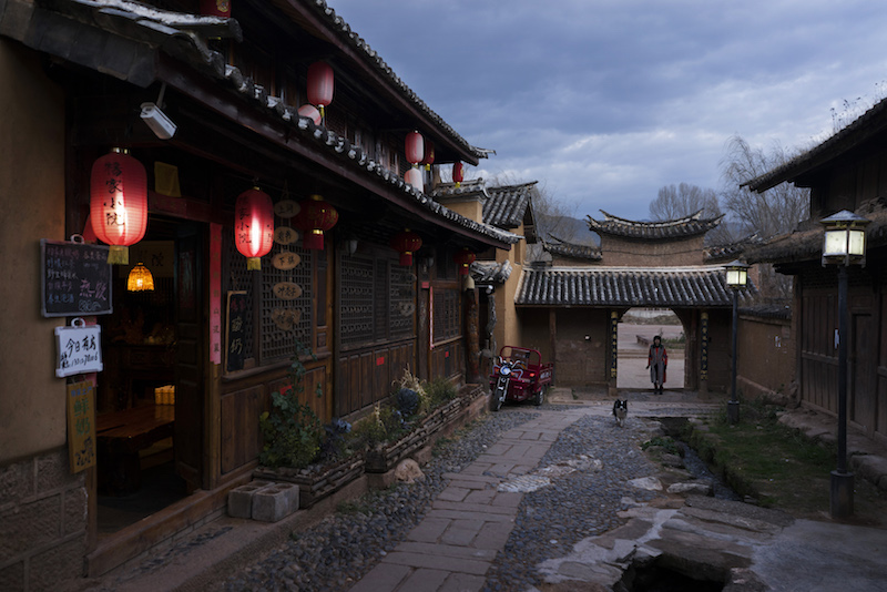 A villager walks through a gate leading to the old town centre of Shaxi, China, January 28, 2016. — Picture by Adam Dean/The New York Times