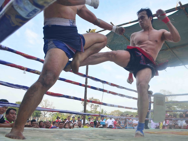 Lethwei fighter Sam Htut throws a low kick against his opponent in a sand-filled ring.u00c2u00a0u00e2u20acu201d Reuters pic