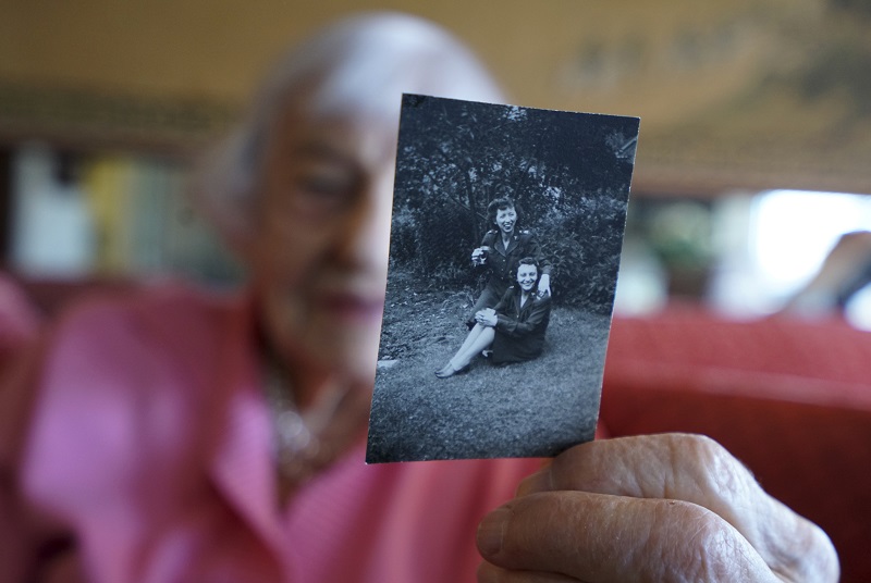 Mimi Greeley, who recently turned 100, shows a photo of herself and friend Ruth u00e2u20acu02dcBrownieu00e2u20acu2122 Girk, who will also soon turn 100, together as WWII nurses, at her apartment in New York, March 2, 2016. u00e2u20acu201d Picture by Nicole Bengiveno/The New York Times