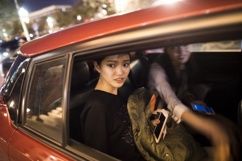 In this picture taken on March 29, 2016, Chinese model Xu Naiyu (left) leaves in a car with her friend after the last show of the day at China Fashion Week in Beijing. — AFP pic