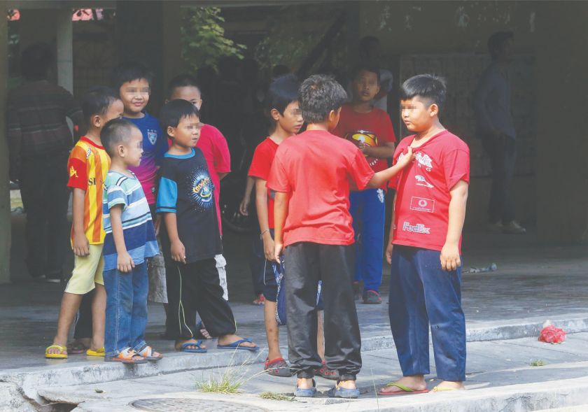 Children at the residential area near the school demonstrate a bullying incident yesterday. u00e2u20acu00a8u00e2u20acu201d Picture by Zuraneeza Zulkifli
