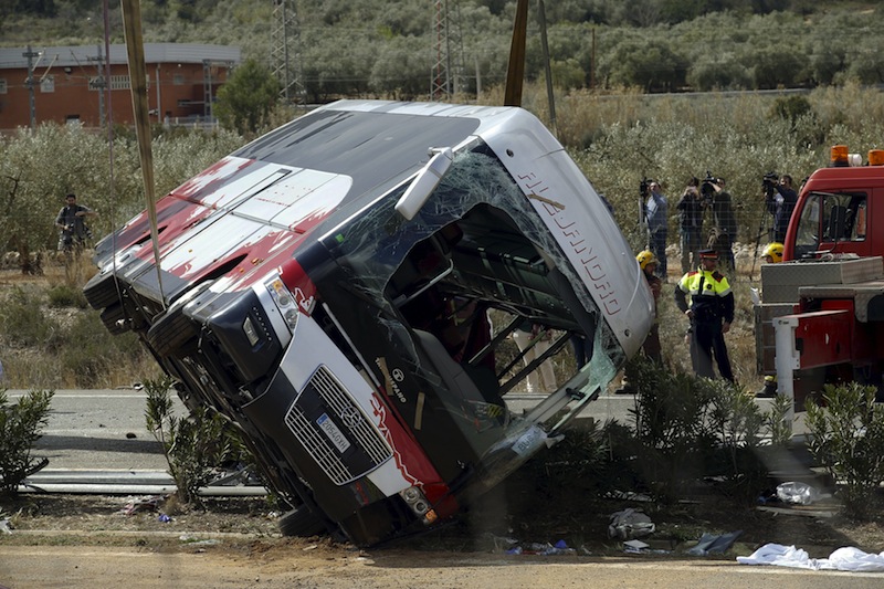 The wreckage of a bus is lifted by a crane after a traffic crash in Freginals, Spain, March 20, 2016. u00e2u20acu201d Reuters pic