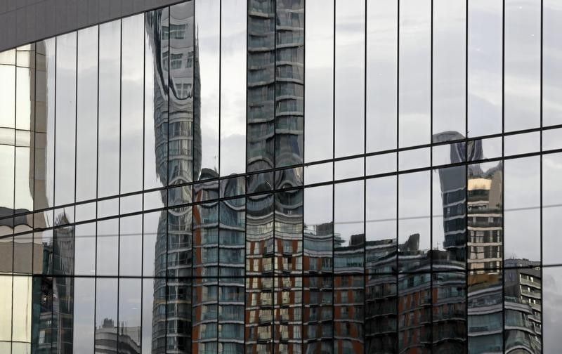 Skyscrapers of banks at Canary Wharf in London are reflected,  October 30, 2015. u00e2u20acu201d Reuters pic