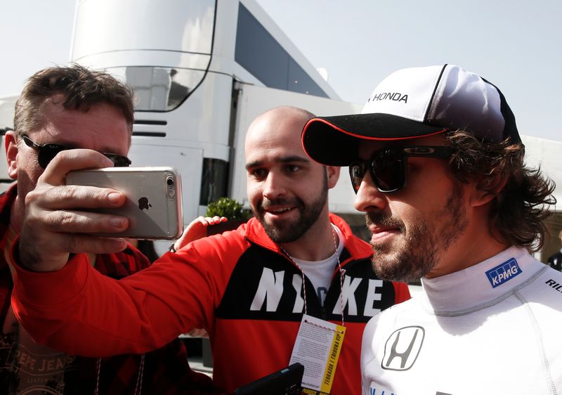 McLaren Formula One driver Fernando Alonso of Spain poses for a selfie with a supporter at the Circuit Barcelona-Catalunya in Montmelo, February 23, 2016. u00e2u20acu201d Reuters pic 