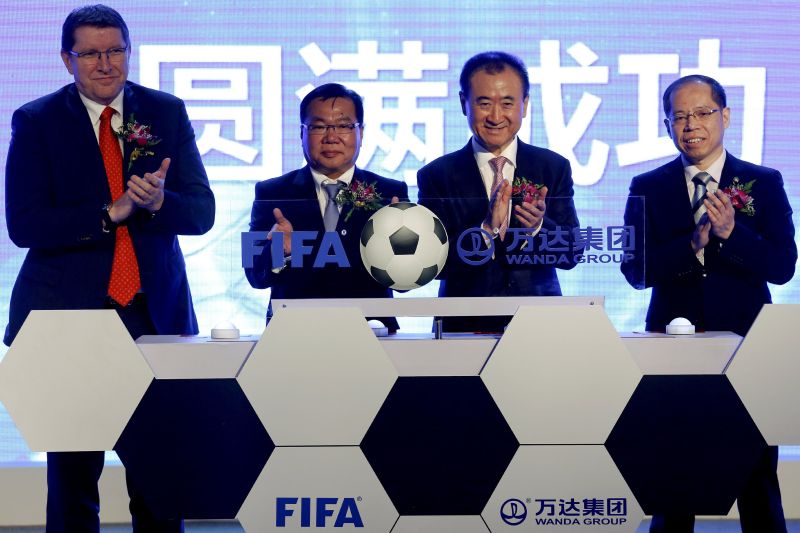 Dalian Wanda Group chairman Wang Jianlin (second right) in Beijing March 21, 2016, with officials from Fifa and the Football Association of China to announce the strategic partnership between the group and Fifa. REUTERS/Damir Sagolj 