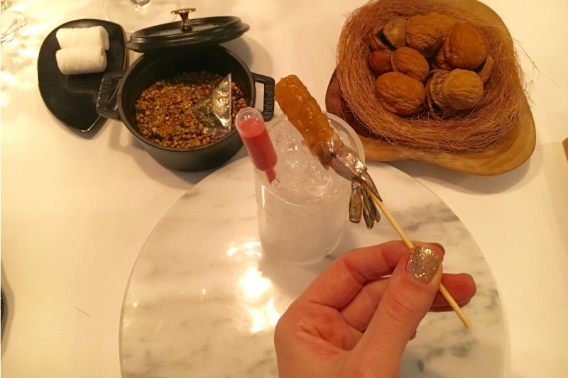 Wardle reviews a restaurant; here, she holds a shrimp with sauce and pickling spices. ― Picture by Gemma Wardle/Zester Daily