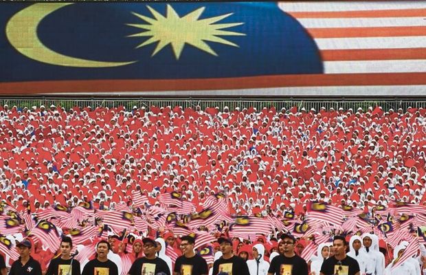 Participants waving the Jalur Gemilang at the Merdeka Day parade in Kuala Lumpur last year. The writer believes every citizen wants to live honourably and with dignity.