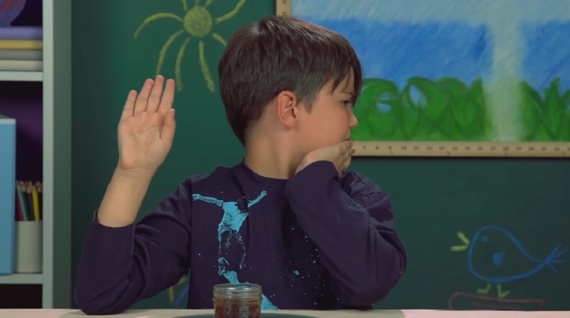 One of the children reacts to chocolate-flavoured soda in this screenshot taken from the React video.