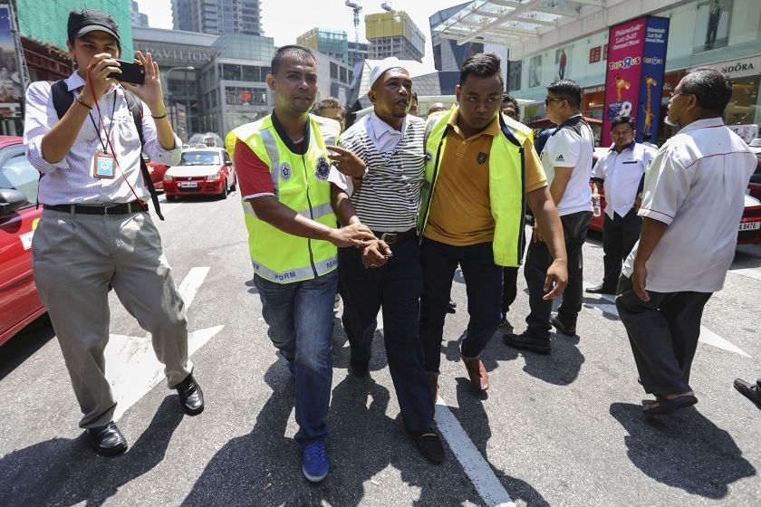 A taxi driver is arrested by police during a protest against SPAD and Uber near Pavilion Kuala Lumpur March 29, 2016. u00e2u20acu201d Picture by Yusof Mat Isa