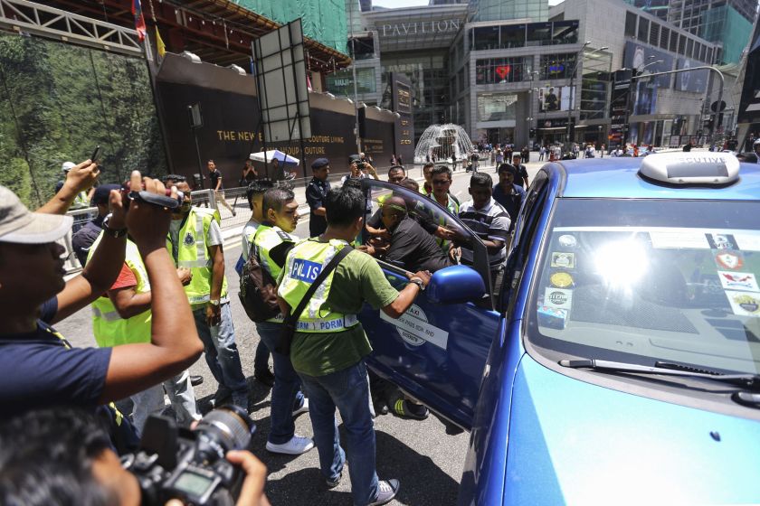 A taxi driver is arrested by police during a protest against SPAD and Uber near Pavilion Kuala Lumpur March 29, 2016. 