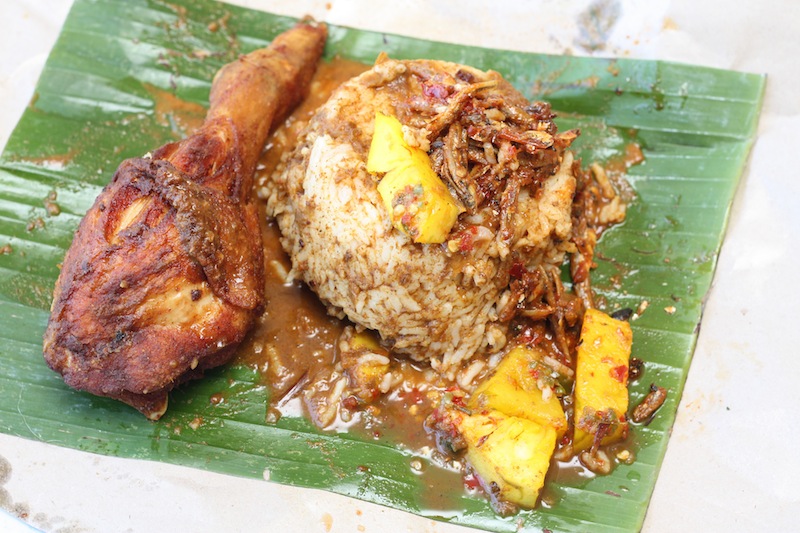 Steamed rice is topped with three kinds of curries, pineapple acar, fried ikan bilis, sambal and paired with a piece of succulent fried chicken.