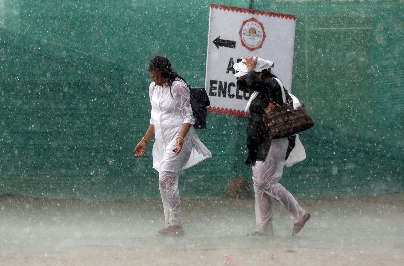 Women arrive in a hailstorm.