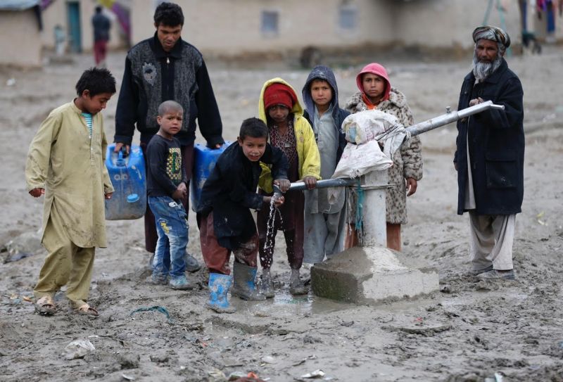 Children drink water from a public water pump on the outskirts of Kabul. u00e2u20acu201d Reuters file pic