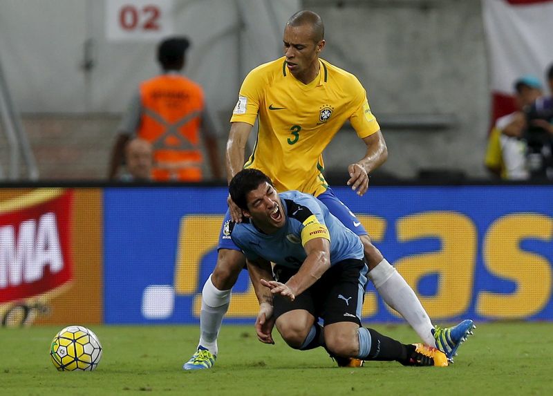 Luis Suarez (front) of Uruguay and Miranda of Brazil in action in World Cup qualifier in Recife, Brazil March 25, 2016. u00e2u20acu201d Reuters pic