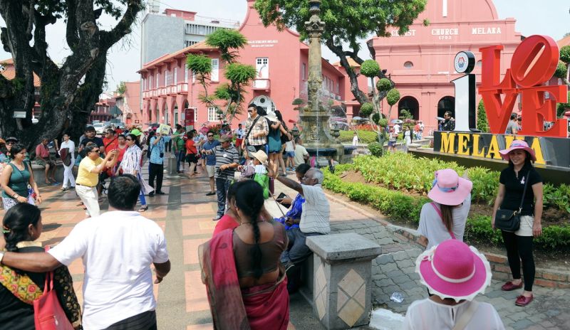 Local and foreign tourists are seen posing for photos in front of the Stadhuys in Malacca, March 18, 2016. u00e2u20acu2022 Bernama pic