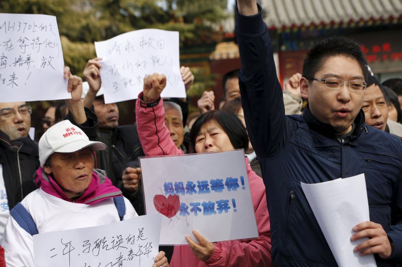 Family members of passengers on board flight MH370 which went missing in 2014, shout slogans in front of a holding area for journalists at Lama Temple in Beijing, China, March 8, 2016. u00e2u20acu2022 Reuters pic