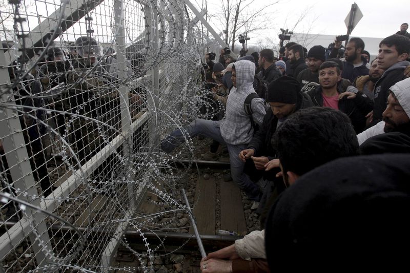 Stranded refugees and migrants try to bring down part of the border fence during a protest at the Greek-Macedonian border, near the Greek village of Idomeni, February 29, 2016. u00e2u20acu201d Reuters pic